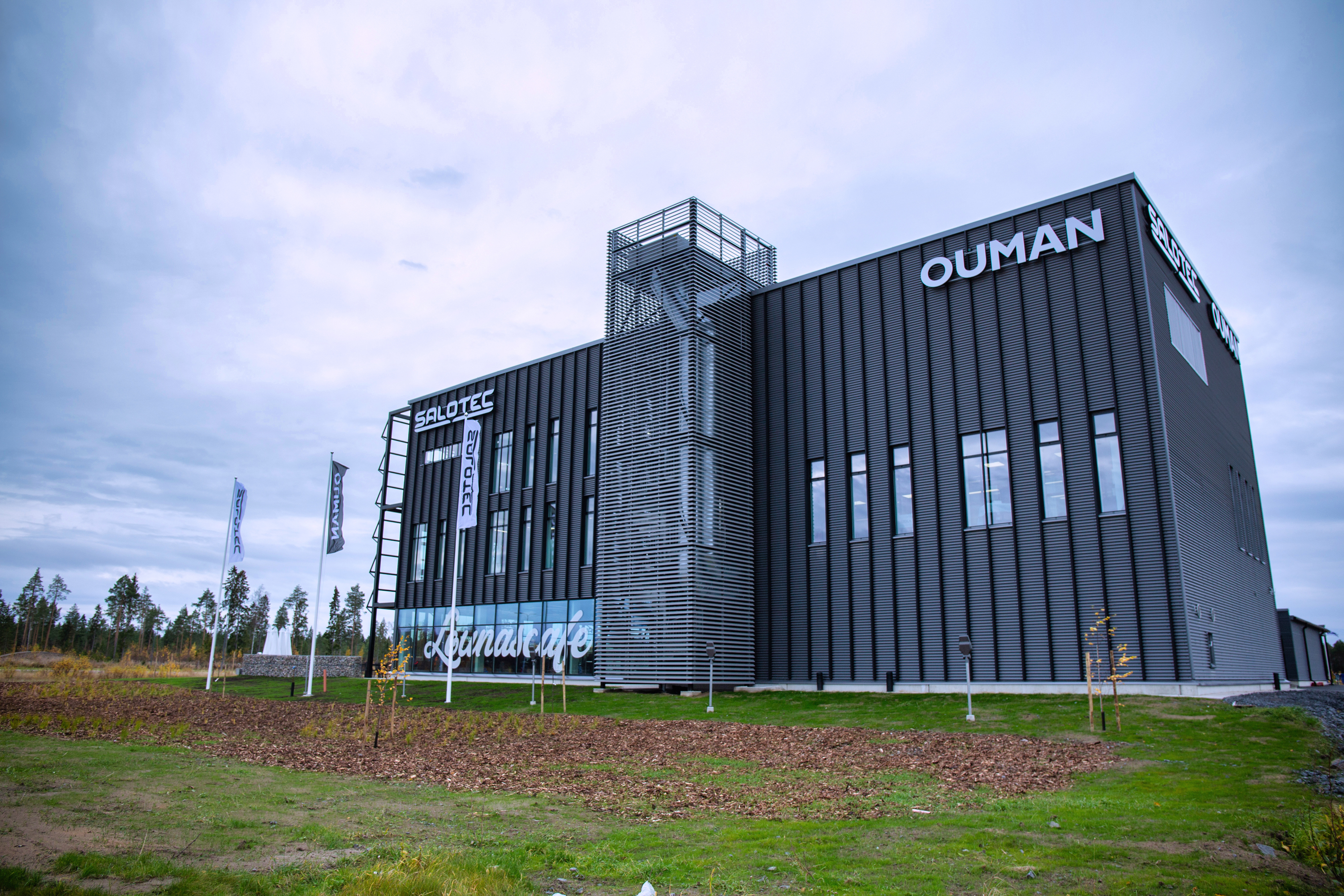 Ouman industrial building with dark metal facade and company signage in Kempele.